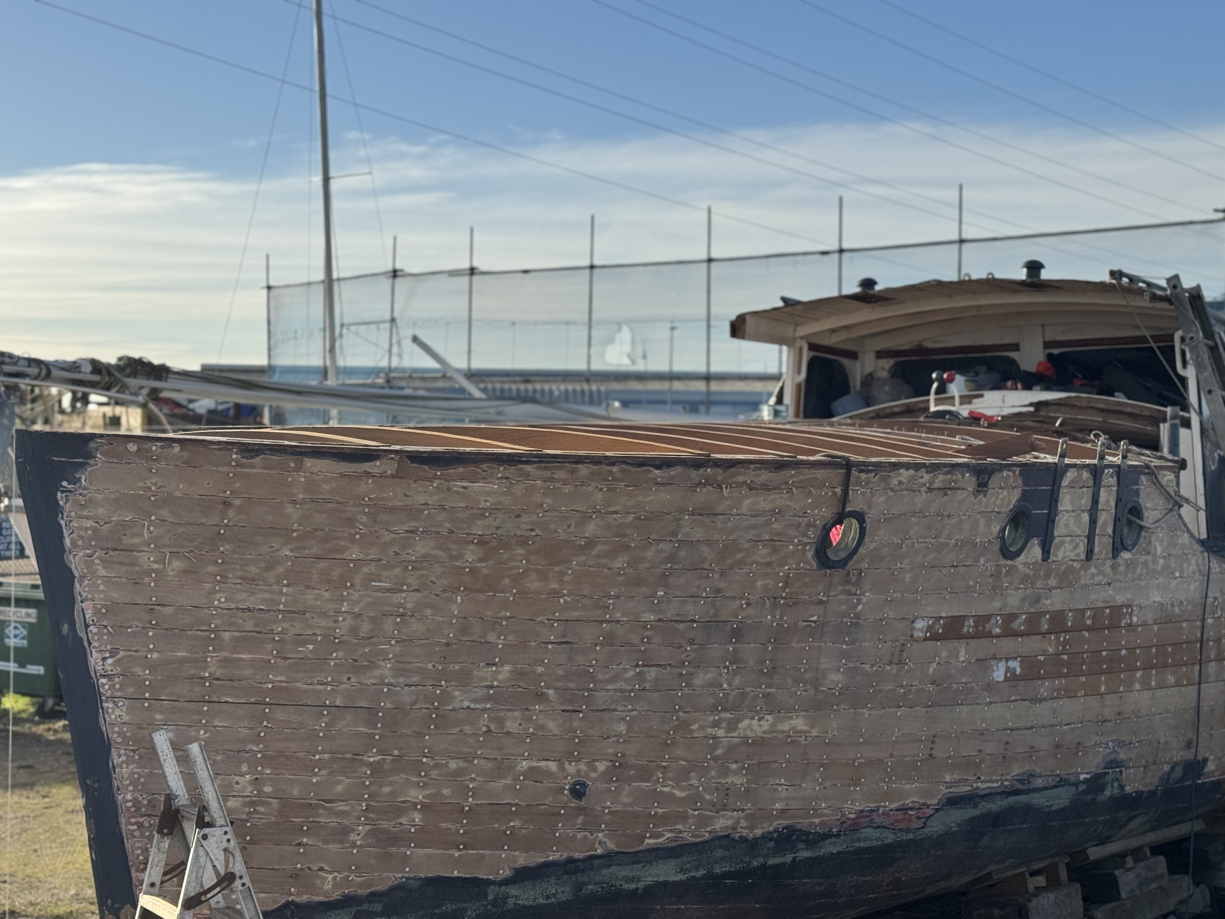 M.V. Gerfalcon undergoing volunteer-led restoration alongside a quay.